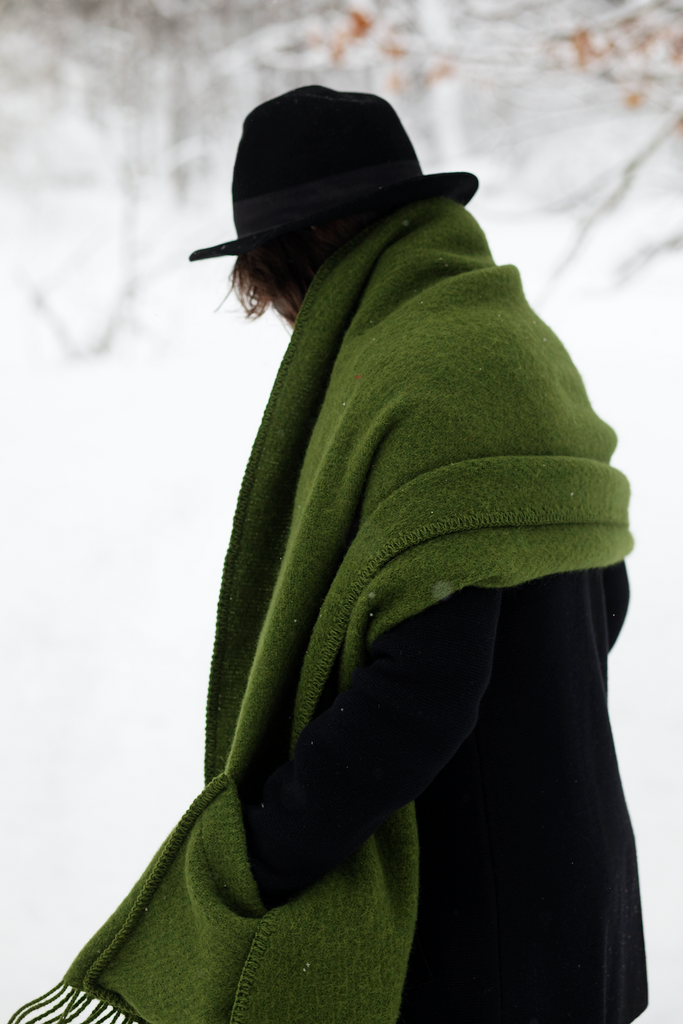 Dame med grønt ullsjal på vinteren.